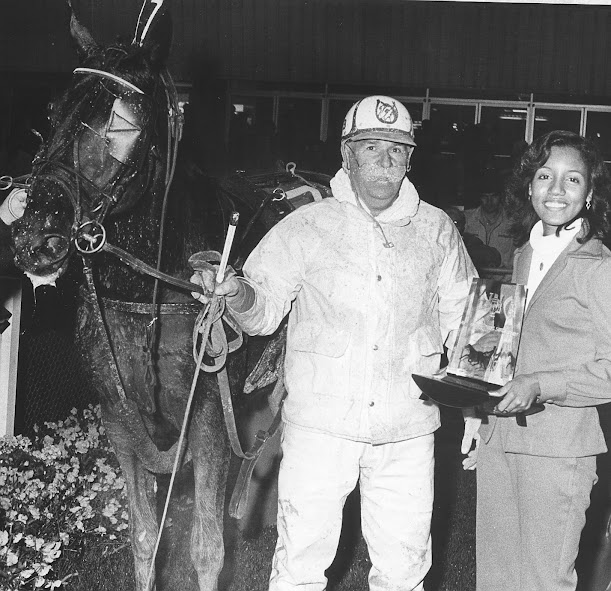 Itldo and owner and driver Lloyd Butler of Dresden receives a trophy for their efforts over a muddy track.